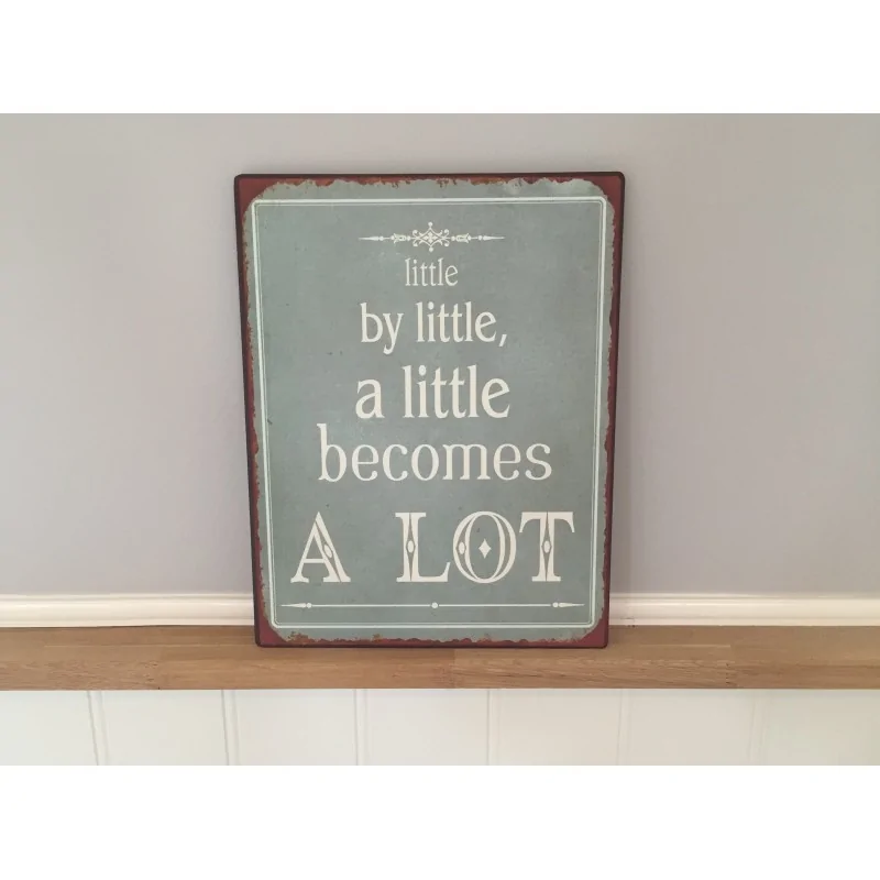 Metalskilt med teksten "little by little.."